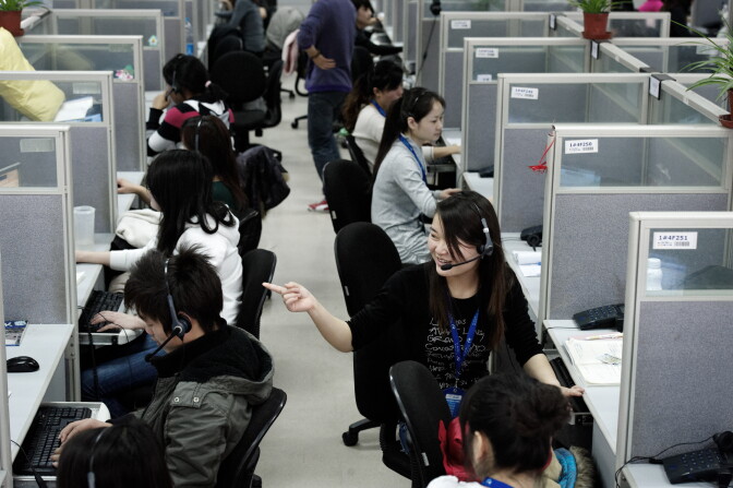 TO GO WITH Lifestyle-tourism-China-Internet-company-Ctrip,FEATURE by D'Arcy Doran
This photo taken on March 9, 2011 shows employees at China-based company Ctrip in the call center of their headquarters in Shanghai. The one-stop China travel service Ctrip.com specializes in discount hotel reservations, cheap airline tickets and package tours.    AFP PHOTO / Andrew Ross (Photo credit should read ANDREW ROSS/AFP/Getty Images)