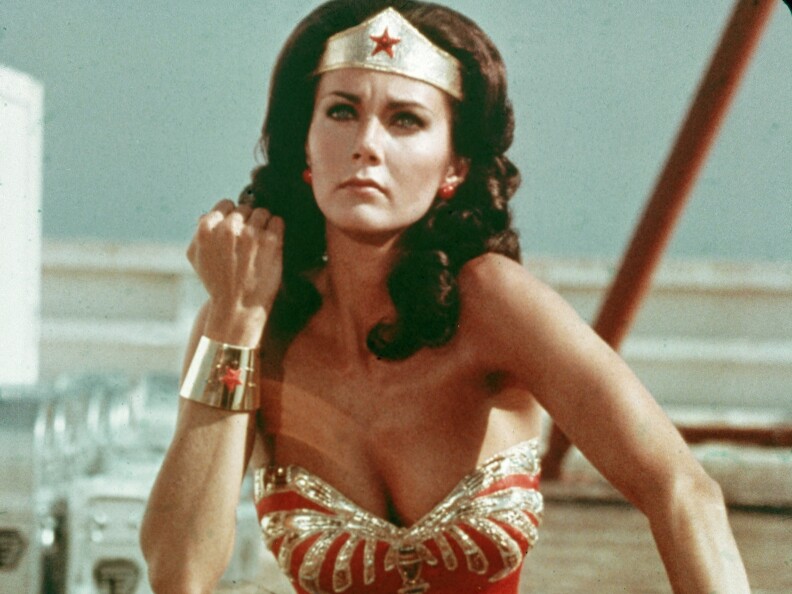 Lynda Carter wears the full Wonder Woman costume with gold headband, wrist cuffs and bustier