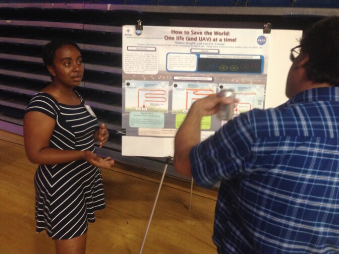 High school science teacher Natalie Wright (left) explains science research she carried out at the California Teachers' Summit at CSU Fullerton. 