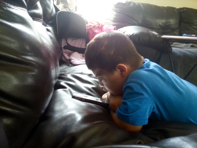 Two-year-old Sean Potvin plays with a smart phone in his grandparents house in Commerce. Outside LA County crews tested soil for lead contamination from the former Exide battery recycling plant. Potvin's family worries he may have been impacted because he has developmental delays and had to undergo brain surgery shortly after he was born.