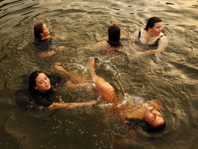Wellspring students go for a swim in the lake just before sunset.