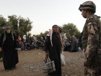 Jordanian soldiers help newly-arrived Syrian refugees after hundreds fleeing the violence in their home country. Most refugees have fled to neighboring countries, but some have ended up in Southern California.