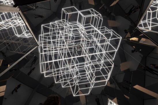 A light installation of geometric shapes reflected by mirrors.