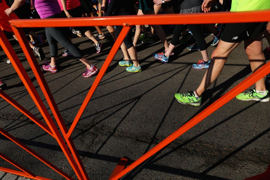 Runners walk to the starting line B.A.A. 5K on April 18, 2015 in Boston, Massachusetts.