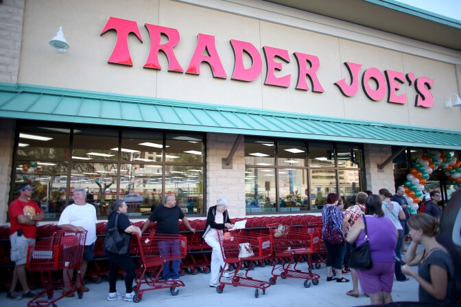 PINECREST, FL - OCTOBER 18: Shoppers lineup as they wait for the grand opening of a Trader Joe's on October 18, 2013 in Pinecrest, Florida. Trader Joe's opened its first store in South Florida where shoppers can now take advantage of the California grocery chains low-cost wines and unique items not found in other stores. About 80 percent of what they sell is under the Trader Joe's private label. (Photo by Joe Raedle/Getty Images)