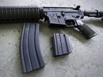 A 30 round magazine, left, and a 10 round magazine, right, rest below an AR-15 rifle, similar to the weapon lost by an Orange County Sheriff's deputy Tuesday. 