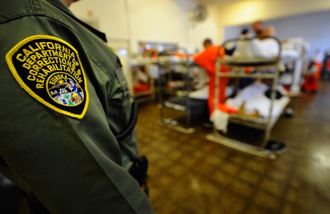 CHINO, CA - DECEMBER 10:  A California Department of Corrections officer speaks to inmates at Chino State Prison in the dayroom of Sycamore Hall that was modified to house prisoners on December 10, 2010 in Chino, California. The U.S. Supreme Court is preparing to hear arguments to appeal a federal court's ruling last year that the California state prison system would have to release 40,000 prisoners to cope with overcrowding so severe that it violated their human rights. More than 144,000 inmates are currently incarcerated in prisons that were designed to hold about 80,000.  (Photo by Kevork Djansezian/Getty Images)
