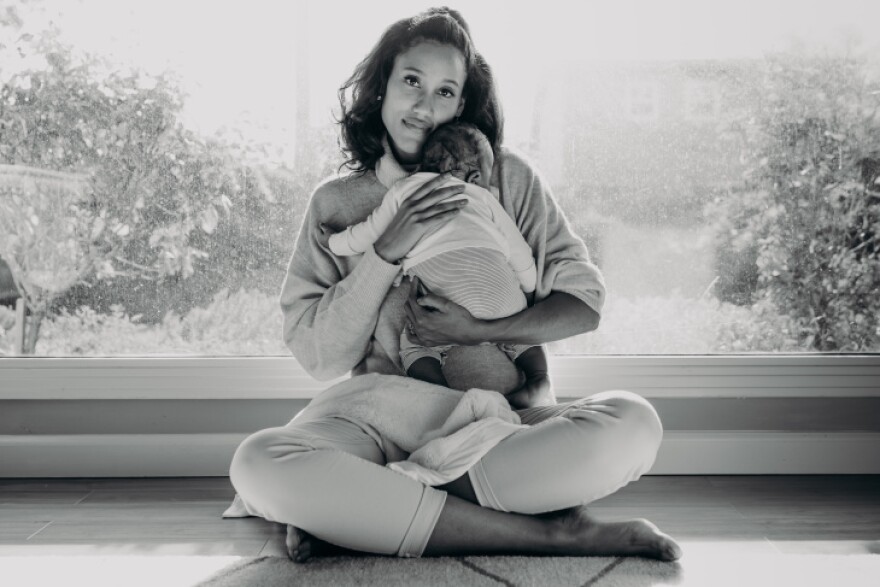 Anna Malaika Tubbs, author of The Three Mothers, holds her infant son, Michael Malakai Tubbs, Jr., in her home.