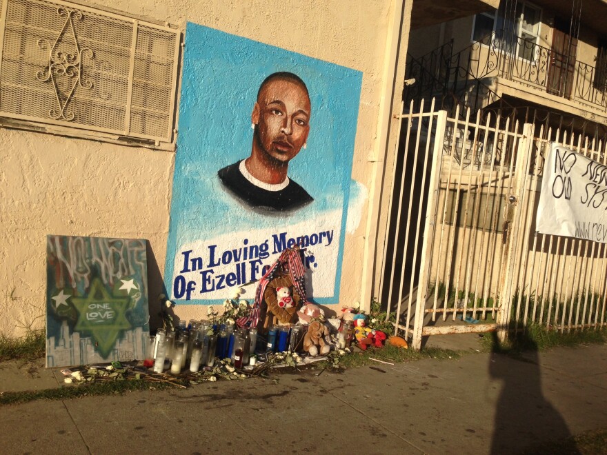 A portrait of Ezell Ford, killed by LAPD officers in August near this spot, is on the wall of a market at 65th Street and Broadway in South Los Angeles