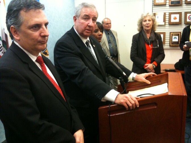 File: Los Angeles County Dist. Atty. Steve Cooley and Deputy Dist. Atty. Sean Carney of the Target Crimes Division address the media after a hearing at the Los Angeles County Superior Court for arson suspect Harry Burkhart.