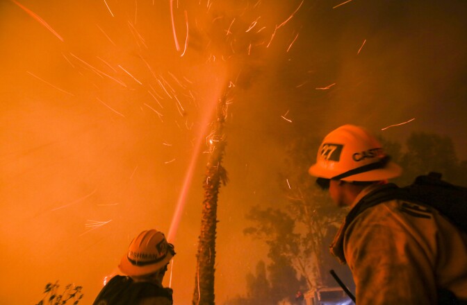 Firefighters battle a wildfire as it burns along a hillside near homes in Santa Paula, California, on December 5, 2017.
Fast-moving, wind-fueled brush fire exploded to about 10,000 acres in Ventura County Monday night, forcing hundreds of people to flee their homes, officials said.  / AFP PHOTO / RINGO CHIU        (Photo credit should read RINGO CHIU/AFP/Getty Images)