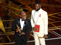 HOLLYWOOD, CA - FEBRUARY 26:  Writer/director Barry Jenkins (L) and writer Tarell Alvin McCraney accept Best Adapted Screenplay for 'Moonlight' onstage during the 89th Annual Academy Awards at Hollywood & Highland Center on February 26, 2017 in Hollywood, California.  (Photo by Kevin Winter/Getty Images)