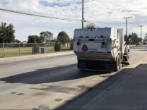 A garbage truck drives along Nichols Lane, which separates Oak Park Elementary School from the waste transfer station operated by Republic Services.