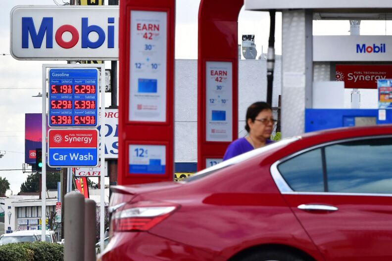 A Mobil station sign gives the cost of a gallon of gasoline as $5.19 for regular and $5.39 for premium, with 10 cent higher costs for those paying with a non-Mobil credit card.