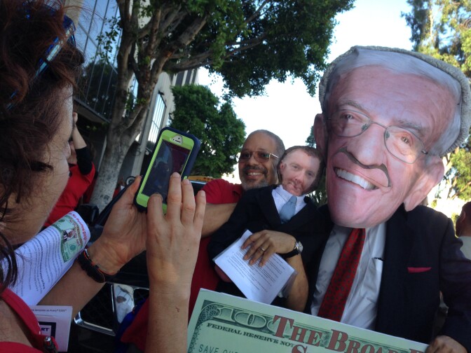 L.A. Unified teacher Elgin Scott holds a likeness of former superintendent John Deasy at a teachers union rally protesting the influence of billionaire Eli Broad in the school district's superintendent search.