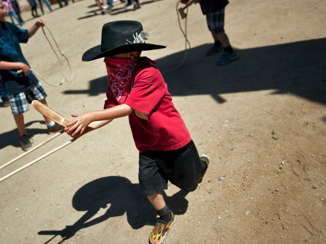Six-year-old Shane Gilliam plays with lassos with his brother and friends during the 20th Annual Cowboy Festival. HBO's series, Deadwood, is filmed at Melody Ranch Studios.