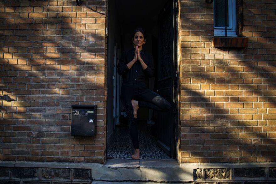 Maddalena, practises yoga at the entrance of her house, in Bagnolet, on the outskirts of Paris, on April 14, 2020, on the 29th day of a strict lockdown aimed at curbing the spread of the COVID-19 (the novel coronavirus). - During the lockdown, everyone acts in a different way: some wear their jogging or pyjama all day long, some read all the time, others clean their home more often than usual, do yoga, cook, speak on the phone, have a drink, re-do their interior, sleep and relax or just spend time with their companion and / or their children. There are as many different ways of experiencing the lockdown through who people are and what they do. (Photo by Elena FUSCO / AFP) / RESTRICTED TO EDITORIAL USE -- TO ILLUSTRATE THE EVENT AS SPECIFIED IN THE CAPTION -- (Photo by ELENA FUSCO/AFP via Getty Images)