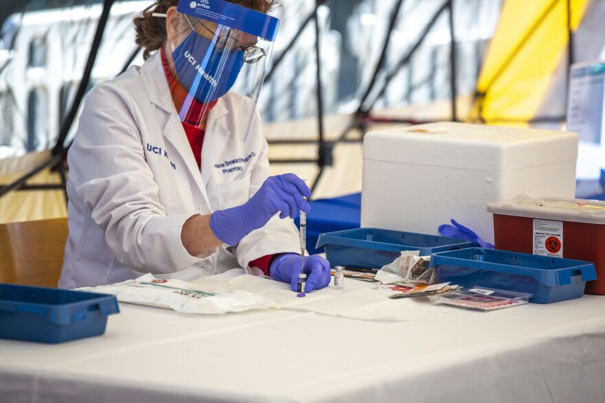 Image of a pharmacist at UCI Health Center preps as they COVID-19 vaccine.