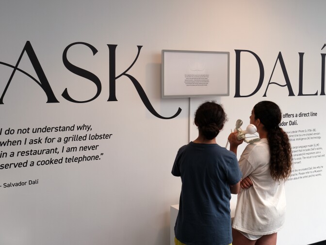 Visitors speak with AI Salvador Dalí via the "lobster phone" at the Dalí Museum in St. Petersburg, Fla.
