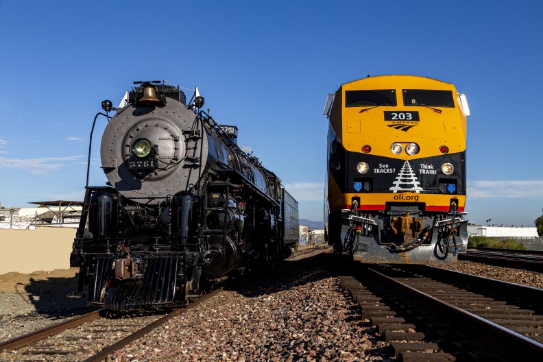 Two trains -- one vintage and one new -- face the camera