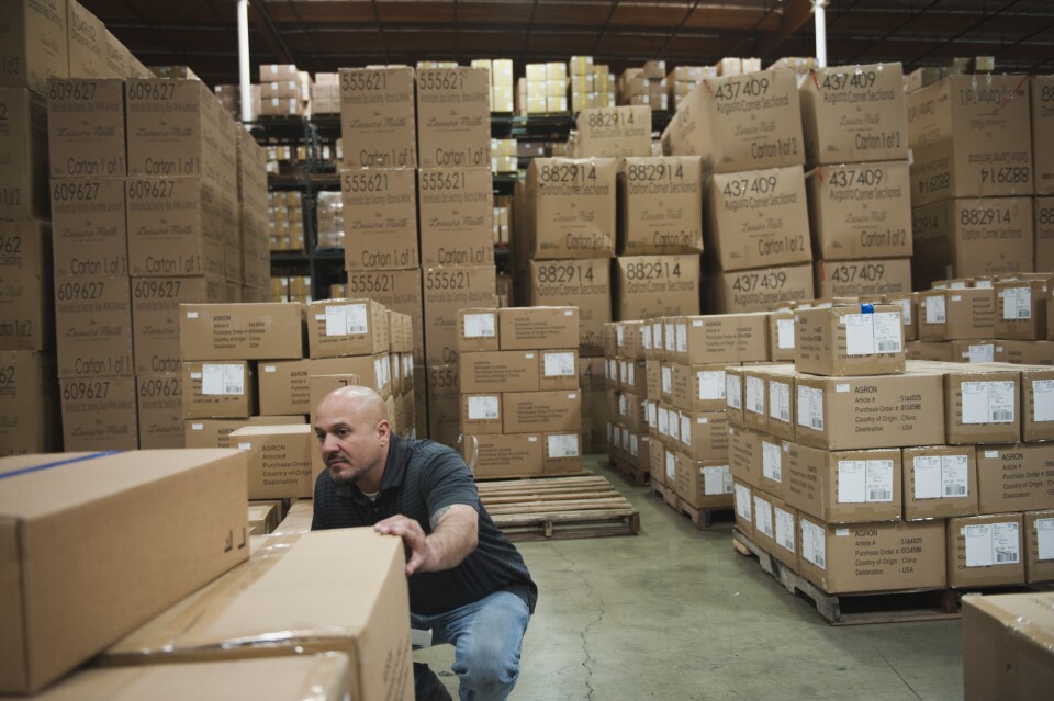 Guillermo Verdugo, a warehouse manager at one of the two facilities owned by Pacific Mountain Logistics in Mira Loma, California, checks stock at the end of the day.