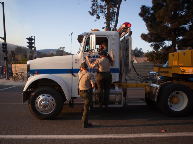A brushfire encroaches on homes in the unincorporated Newbury Park neighborhood west of Thousand Oaks in Ventura County.