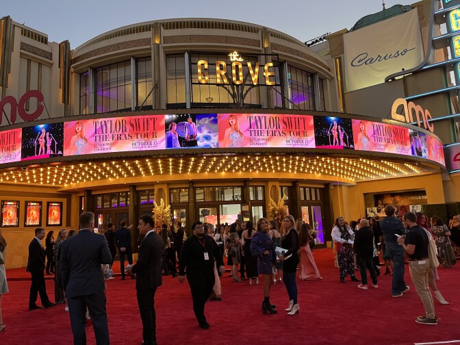 People stand outside of a movie theater