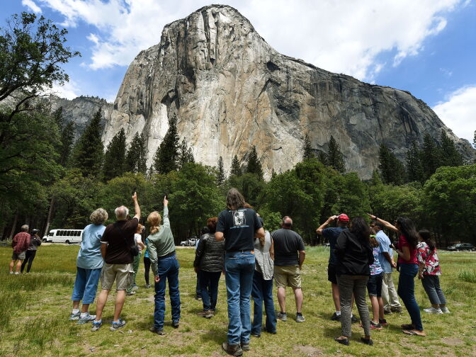 Visitors look up at the El Capitan monolith in the Yosemite National Park in California. 