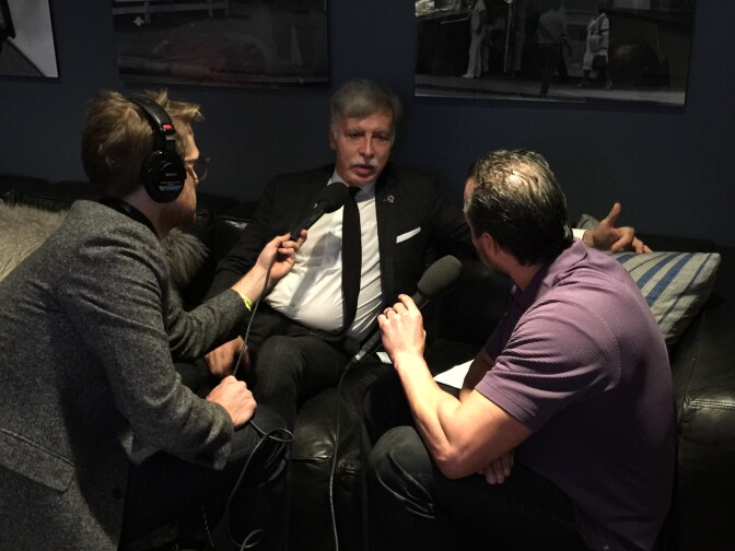 Take Two host A Martinez (right) and producer Jacob Margolis (left) interview Los Angeles Rams owner Stan Kroenke (center).