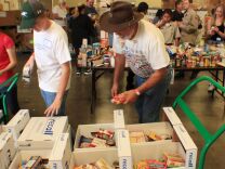 
Volunteers pack up thousands of pounds of food as part of Rotary Club sponsored drive on Saturday at Second Harvest Food Bank in Riverside. 

