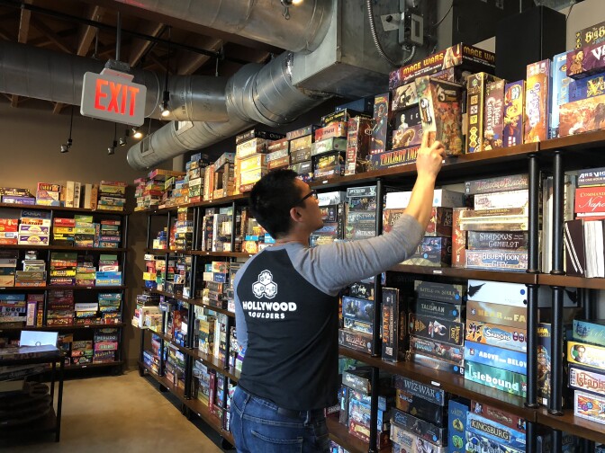 Patron Wilson Yan has trouble deciding between the 1500+ titles