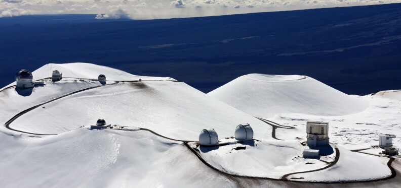 FILE - This Jan. 6, 2009, file photo shows astronomy observatories atop Mauna Kea, a dormant volcano on Hawaii’s Big Island where some Native Hawaiians have been peacefully protesting the construction of what would be one of the world’s largest telescopes. Astronomers have spent the last 40 years observing our universe and helping make some of the most significant discoveries in their field from this remote location. If the highly contested Thirty Meter Telescope is constructed on the site, scientists say they will be able to explore more of the universe’s unsolved mysteries. (AP Photo/Tim Wright, File)