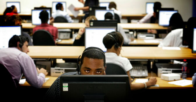 LONDON - JULY 23: Workers at one of the 19 national pandemic flu service call centres in the country,  answer calls from people concerned about swine flu, July 23, 2009 in London, England. Over 1500 people have been employed to man these call centres as concerns about swine flu increase. (Photo by Richard Pohle/WPA Pool/Getty Images)