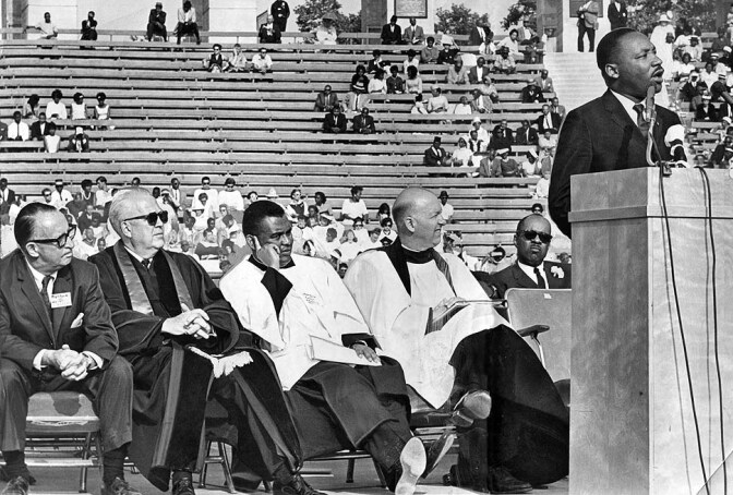 The Rev. John Burt, seated at far right, listens as Martin Luther King Jr. addresses 15,000 people at the Coliseum during an interfaith rally in 1964. Burt helped organize massive civil rights rallies in Los Angeles. -- PHOTOGRAPHER: Los Angeles Times

 1964 staff file photo of Martin Luther King speaking at civil rights rally. From left in front row is entertainer Walter O'Keefe, the Rev. Myron C. Cole, The Rev. Joseph Francis and the Rev. John H. Burt. 