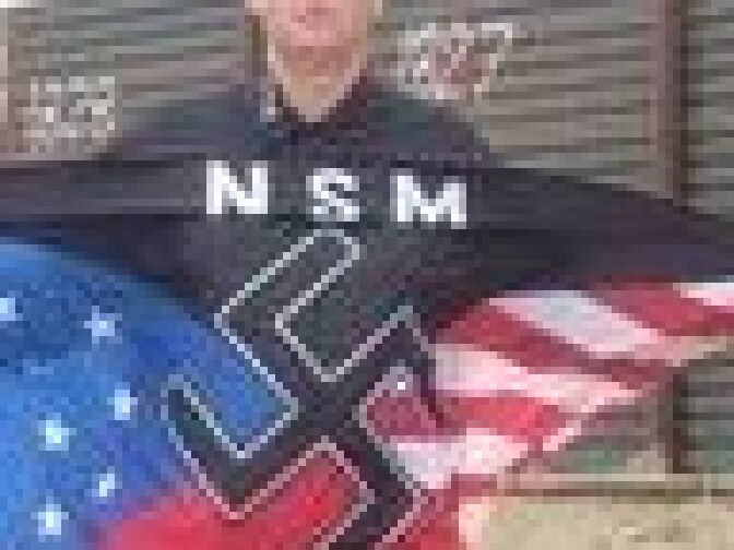 National Socialist Movement's Jeff Hall with NSM flag. 