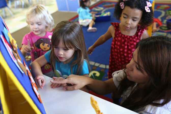 SAN DIEGO, CA - OCTOBER 01:  Children at Scripps Ranch KinderCare in San Diego play in their classroom on October 1, 2013 in San Diego, CA. Later, LuAnn Cline, a Prekindergarten teacher at the center, was surprised with the Early Childhood Educator Award and a $10,000 check from Knowledge Universe.  (Photo by Robert Benson/Getty Images for Knowledge Universe)