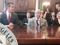 Mayor Eric Garcetti announces a $1.4 billion settlement of a lawsuit brought by disabled residents over broken city sidewalks and missing curb ramps. Attorney Guy Wallace, center, represented wheelchair user Lillibeth Navarro and other plaintiffs in the class action.