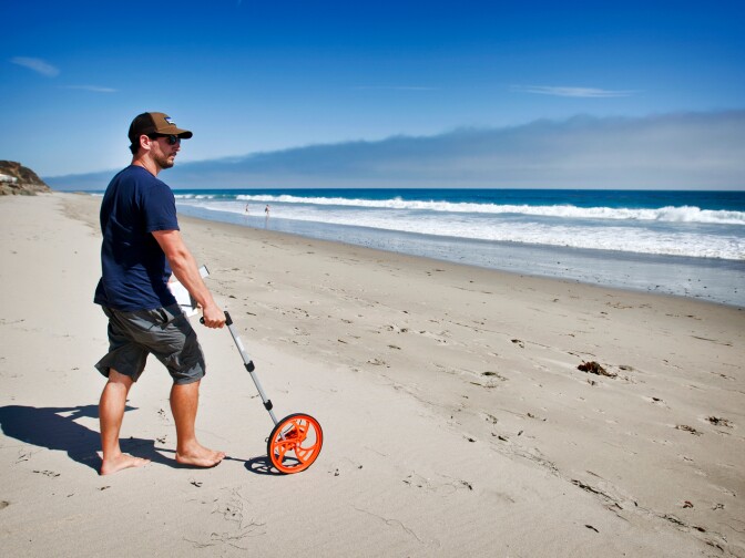 Nick Schooler, a UCSB graduate student in marine science, takes down tide measurements of a Malibu beach on July 24. Once a month, UCSB researchers spend three days tracking the crustaceans in the area.