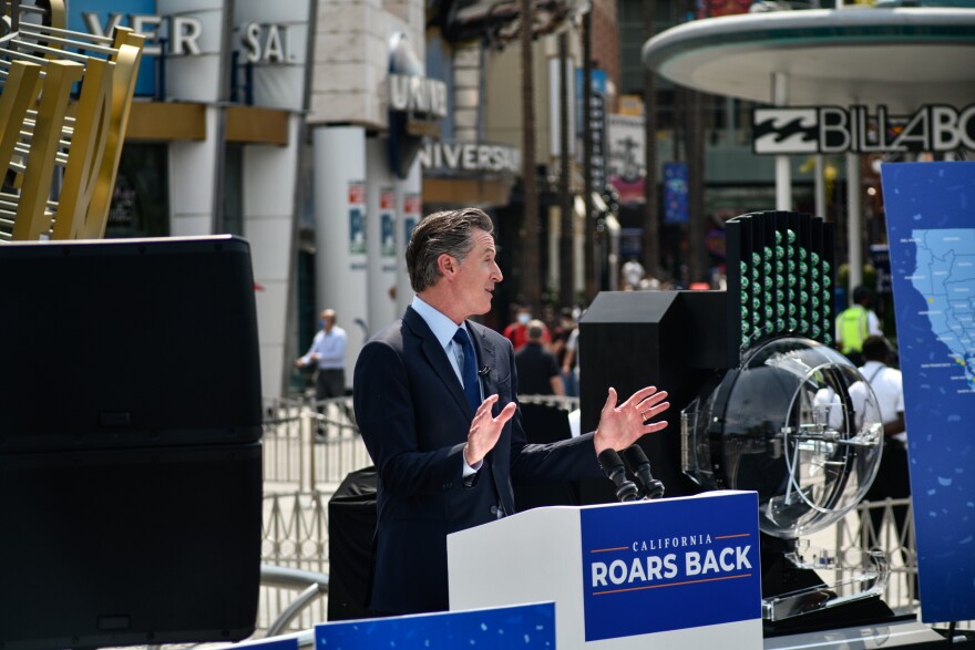 Image of Gov. Gavin Newsom delivering a news conference at Universal Studios in Universal City.