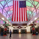 EL PASO, TEXAS - NOVEMBER 12: A worker cleans near an American flag and Christmas decorations in the mostly empty El Paso International Airport amid a surge of COVID-19 cases on November 12, 2020 in El Paso, Texas. Texas eclipsed one million COVID-19 cases November 11th with El Paso holding the most cases statewide. More than 1,000 are hospitalized with COVID-19 in El Paso with around 300 of those patients in the ICU amid a court battle over a shutdown of nonessential businesses. (Photo by Mario Tama/Getty Images)