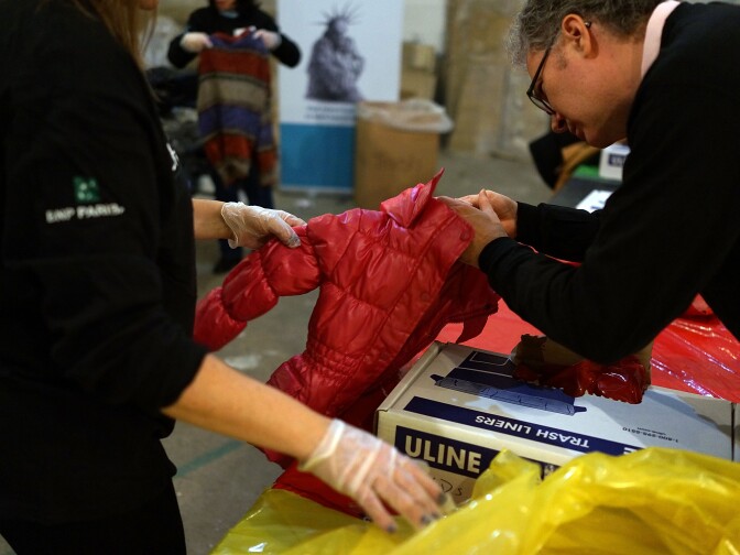 Volunteers sort coats at the annual New York Cares coat drive on December 16, 2013 in New York City.