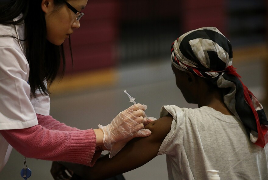 OAKLAND, CA - DECEMBER 19:  A woman receives a free flu shot from a Walgreens employee during a free flu shot clinic at Allen Temple Baptist Church on December 19, 2014 in Oakland, California. Oakland residents received no cost flu shots during a flu shot clinic at Allen Temple Baptist Church.  (Photo by Justin Sullivan/Getty Images)