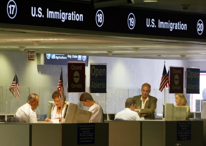 MIAMI - JULY 2:  MIAMI - JULY 2:  U.S. Immigration  inspectors check passports July 2, 2002 at Miami International Airport in Miami, Forida. Inspectors are using the new multi-agency DataShare database which inspectors use to view not only biographic information but also pictures of visa holders. At more than 300 ports of entry across the U.S. the new system is being used for visa holders who receive their documents at consular posts around the world. While information on  immigrant visas has been available through DataShare since 1995, information on temporary visitors, or non-immigrants, has been widely available on DataShare only since January of this year. The addition of non-immigrant information to the DataShare system was put on a fast-track immediately following the September terrorist attacks.  (Photo by Joe Raedle/Getty Images) 