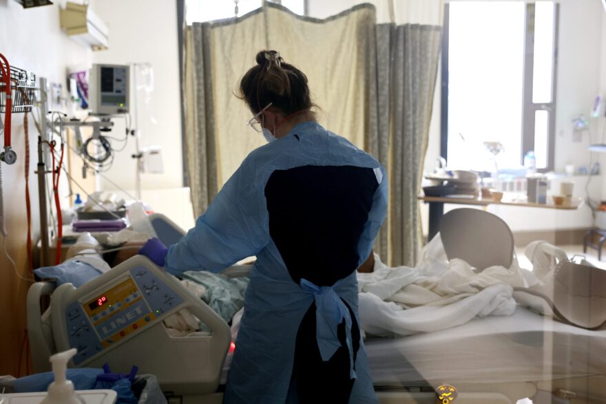 Nurse checks on a patient in the acute care COVID-19 unit at the Harborview Medical Center in Seattle, Washington.