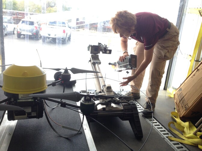 Robin Murphy, director of the Center for Robot-Assisted Search and Rescue at Texas A&M University, adjusts a robot used in hazardous waste cleanup.