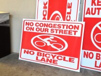 Anti-bike lane signs like these have been popping up on storefront windows in Colorado Boulevard in Eagle Rock.