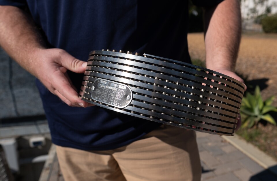 A man holding a metal ring.