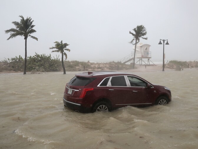 FORT LAUDERDALE, FL - SEPTEMBER 10:  A car sits abandoned in storm surge along North Fort Lauderdale Beach Boulevard as Hurricane Irma hits the southern part of the state September 10, 2017 in Fort Lauderdale, Florida. The powerful made landfall in the United States in the Florida Keys at 9:10 a.m. after raking across the north coast of Cuba.  (Photo by Chip Somodevilla/Getty Images)