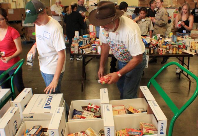 
Volunteers pack up thousands of pounds of food as part of Rotary Club sponsored drive on Saturday at Second Harvest Food Bank in Riverside. 


