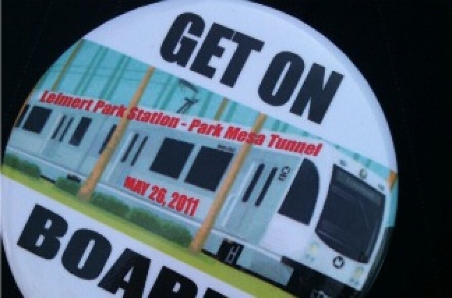 Supporters of a Leimert Park Village stop on the Metro's proposed Crenshaw light rail wear these pins.